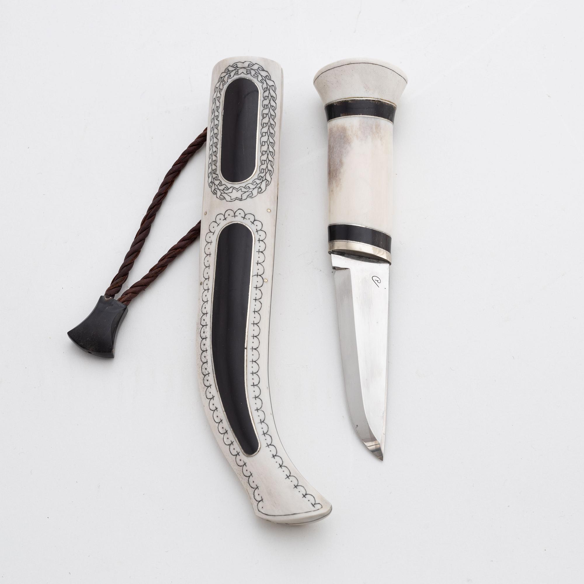 A reindeer horn knife with buffalo inlays by Bertil Fällman, signed.