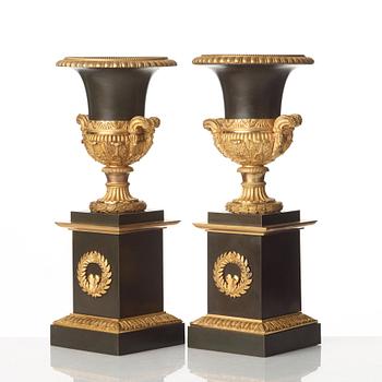 A pair of French Empire early 19th century gilt and patinated bronze urns.