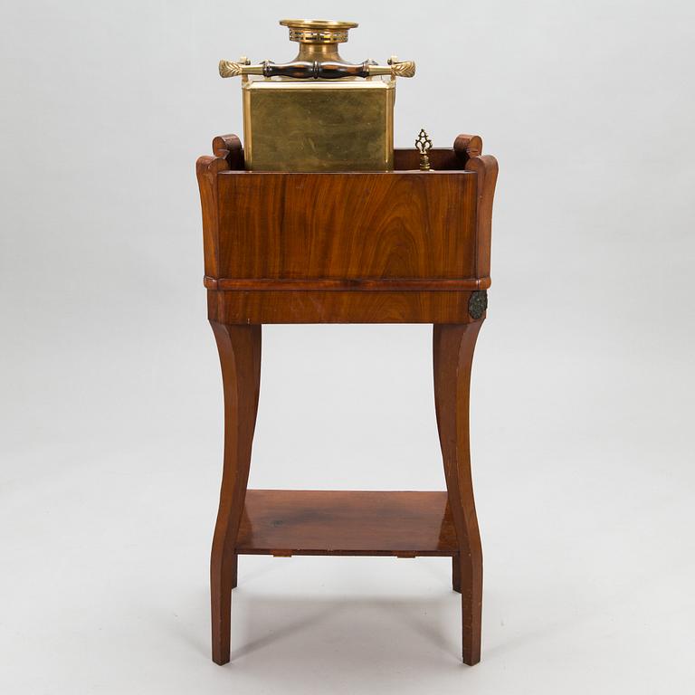 A brass samovar in a stand with a Kuznetsov porcelain teapot and bowl, latter half of the 19th century and early 1900s.