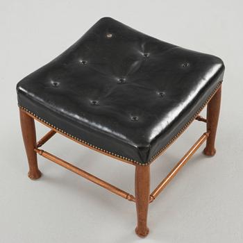 A Josef Frank mahogany and black leather stool, Svenskt Tenn, model 902.
