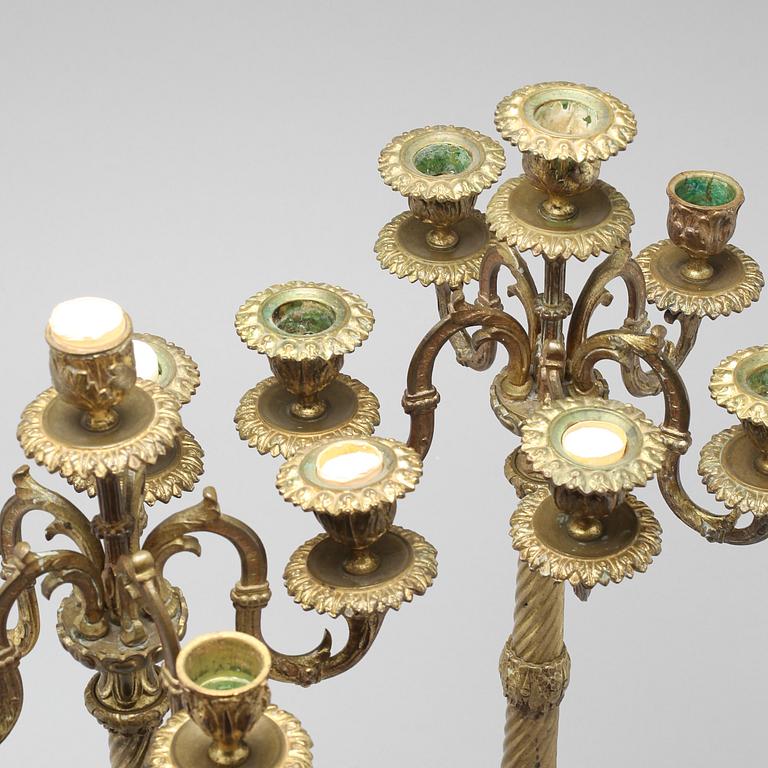 A pair of brass candelabras, 19th century.