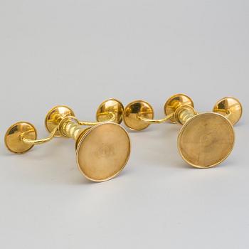 a pair of brass candelabras by Gottfrid Carlsson Eskilstuna.