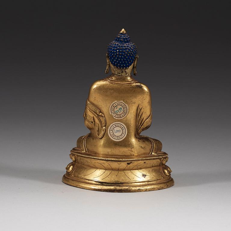 A seated Sino-Tibetan part gilt bronze figure of Amithaba Buddha, 18th Century.