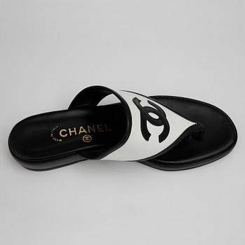 CHANEL, a pair of black and white sandalettes.