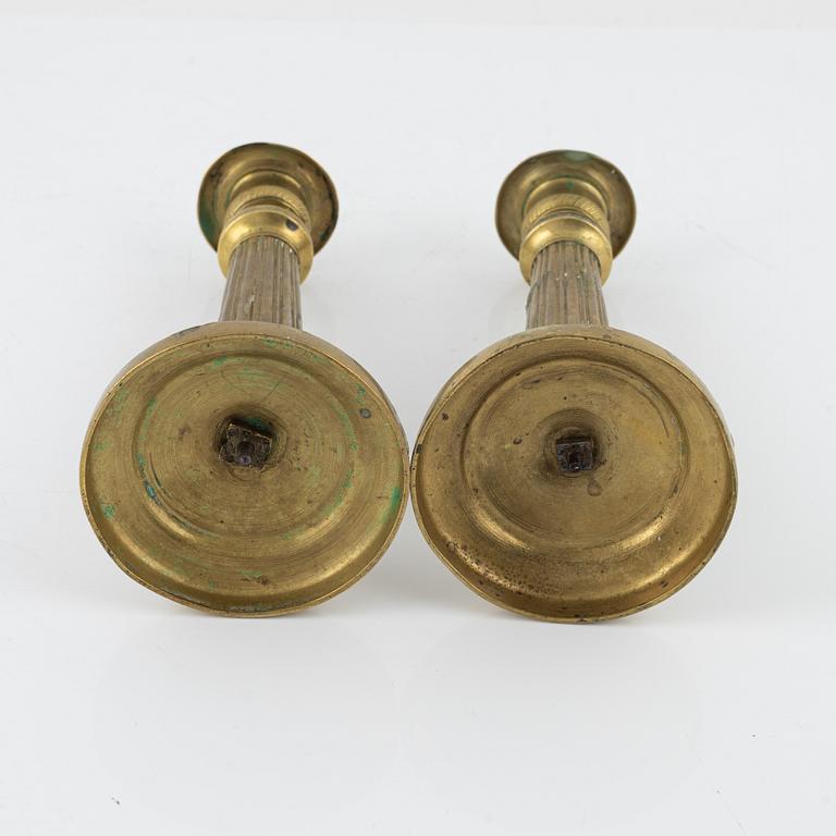 A pair of Empire bronze candlesticks, first half of the 19th Century.