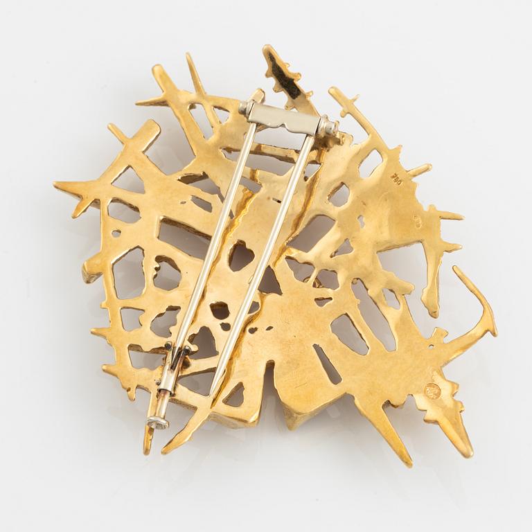 An 18K gold brooch set with faceted rubies.