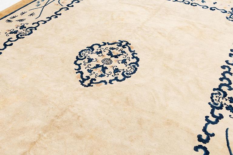 An antique Chinese carpet, 404 x 304 cm.