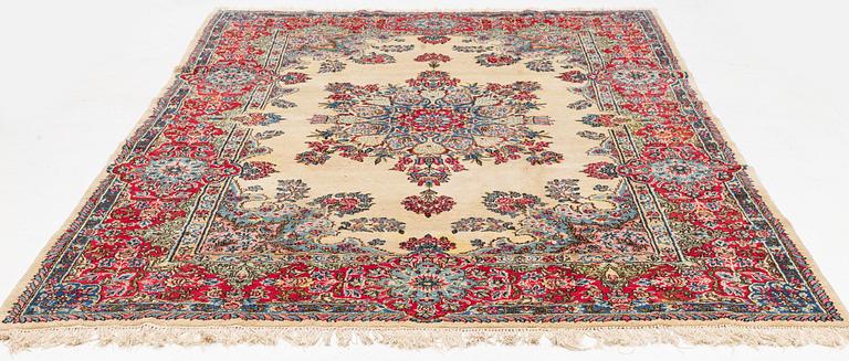 A carpet, old Kerman, approx. 314 x 210 cm.