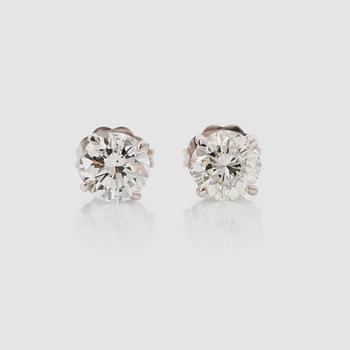 1351. A pair of brilliant-cut diamond solitaire earrings. Total carat weight circa 1.21 cts. Quality circa J/SI.