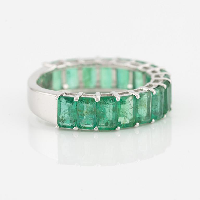 Ring with emerald-cut emeralds.