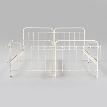 A pair of bed frames and bedside tables, second half of the 20th Century.