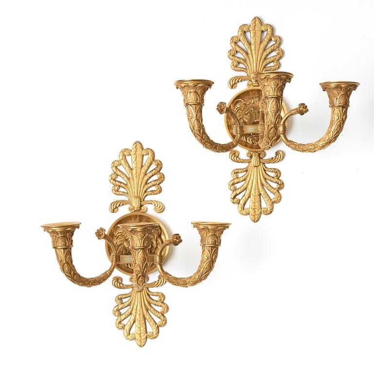 A pair of French Empire early 19th century three-light wall-lights.