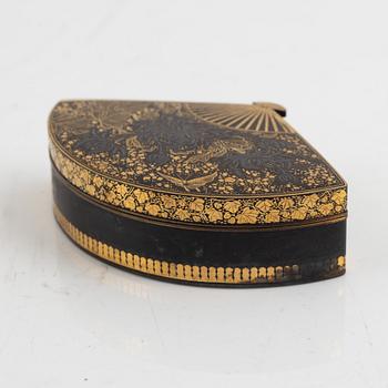 A Japanese gilt-bronze fan-shaped box and gilt iron tsuba with mei inscription, Meiji period (1868-1912).