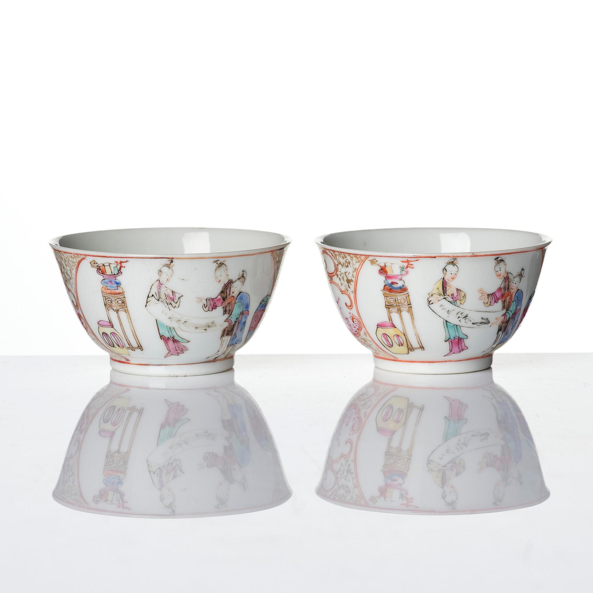 A pair of famille rose 'figural' tea cups with saucers, Qing dynasty, Qianlong (1736-95).