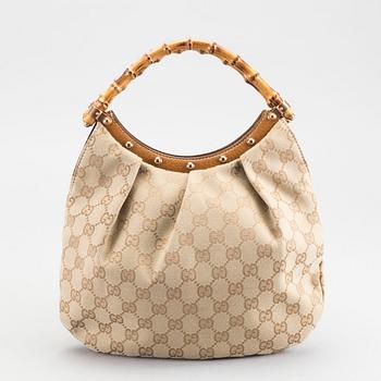 A GUCCI BAG, "STUDDED  BAMBOO HANDLE".