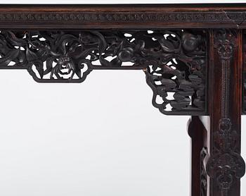 A massive zitan recessed-leg long table 'Jiaotousun Qiotouan', Qing dynasty, 19th century.