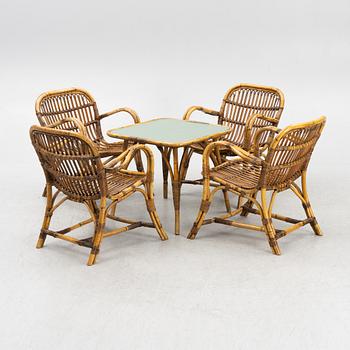 A set of four armchairs and a table, 1940's/50's.