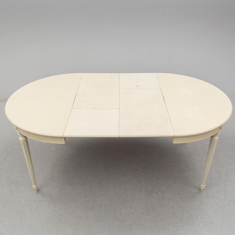 A set of eight chairs and a dining table. Gustavian style, second half of the 20th century. 2 leaves included.