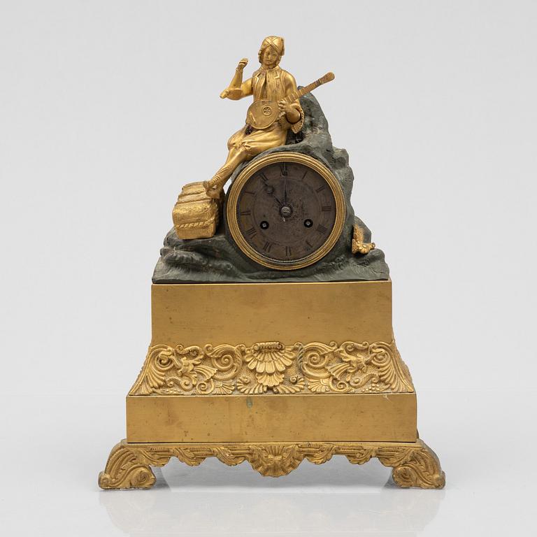 A French late Empire ormolu and patinated mantel clock, first part 18th century.