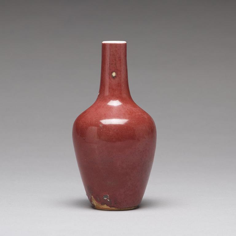 A sang de boef vase and bowl and an enamelled cup with cover and stand, Qing dynasty (1664-1912).