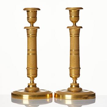 A pair of French gilded Empire candlesticks.