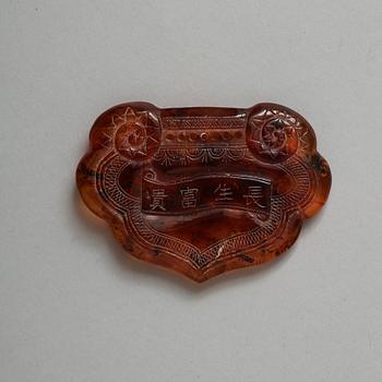 A carved Ruyi-shaped piece of Amber, early 20th Century.