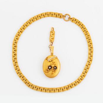 An 18K gold locket set with rose-cut diamonds and pearls with a chain.