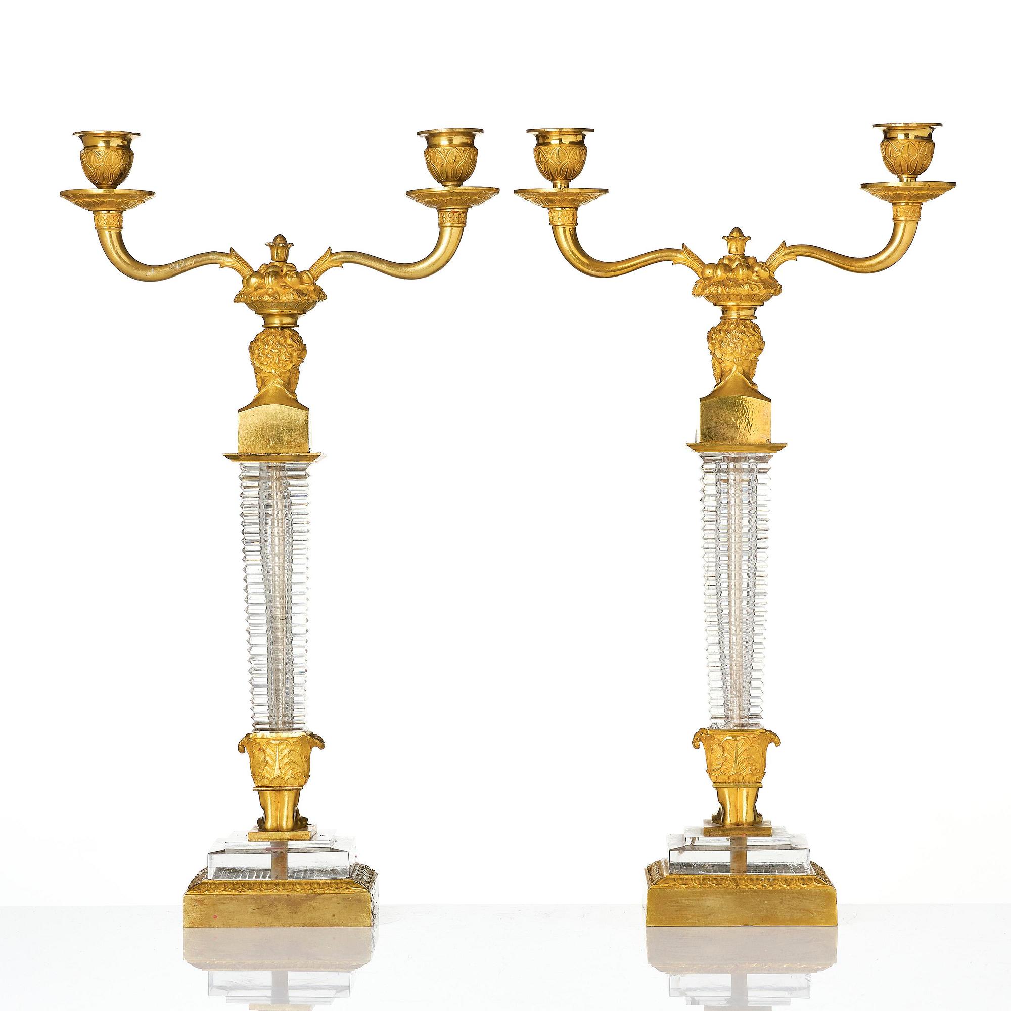 A pair of Empire ormolu and cut glass two-branch candelabra, Paris, early 19th century.