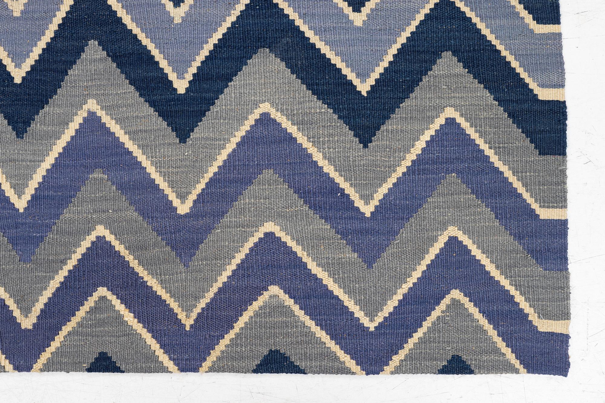 A flat-woven rug, c. 240 x 170 cm.