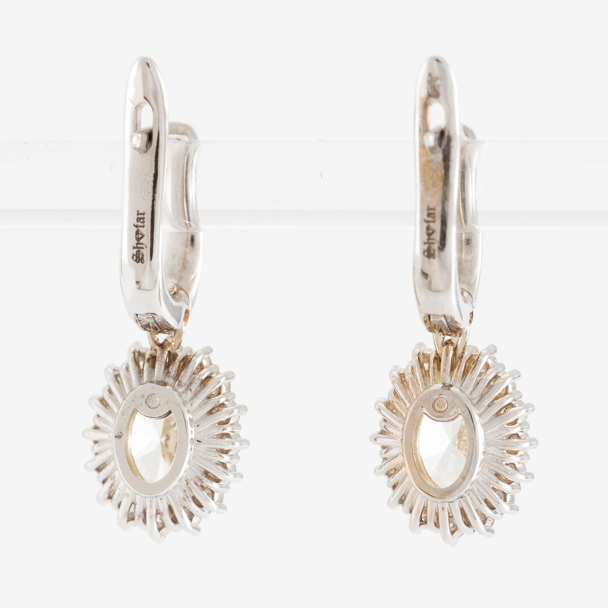 Earrings 18K white gold set with oval-cut diamonds, accompanied by GIA report.