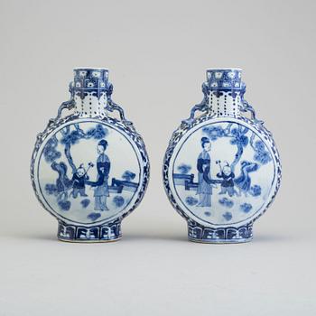 Two similar blue and white porcelain moon flasks, Qing dynasty, late 19th century.