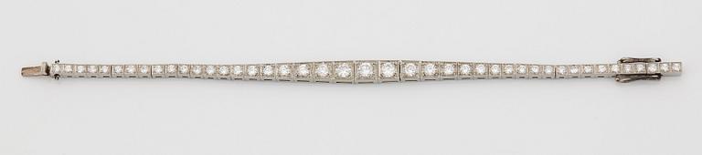 A platinum bracelet set with round brilliant-cut diamonds.