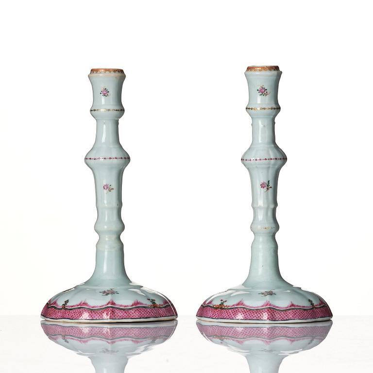 A pair of famille rose candle sticks, Qing dynasty, Qianlong (1736-95).