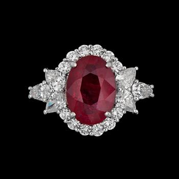 A ruby, app. 4.02 ct. framed by diamonds tot. app. 1.38 cts ring.