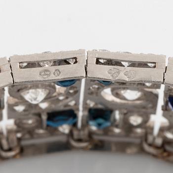 A platinum bracelet set with old-cut diamonds and step-cut sapphires.