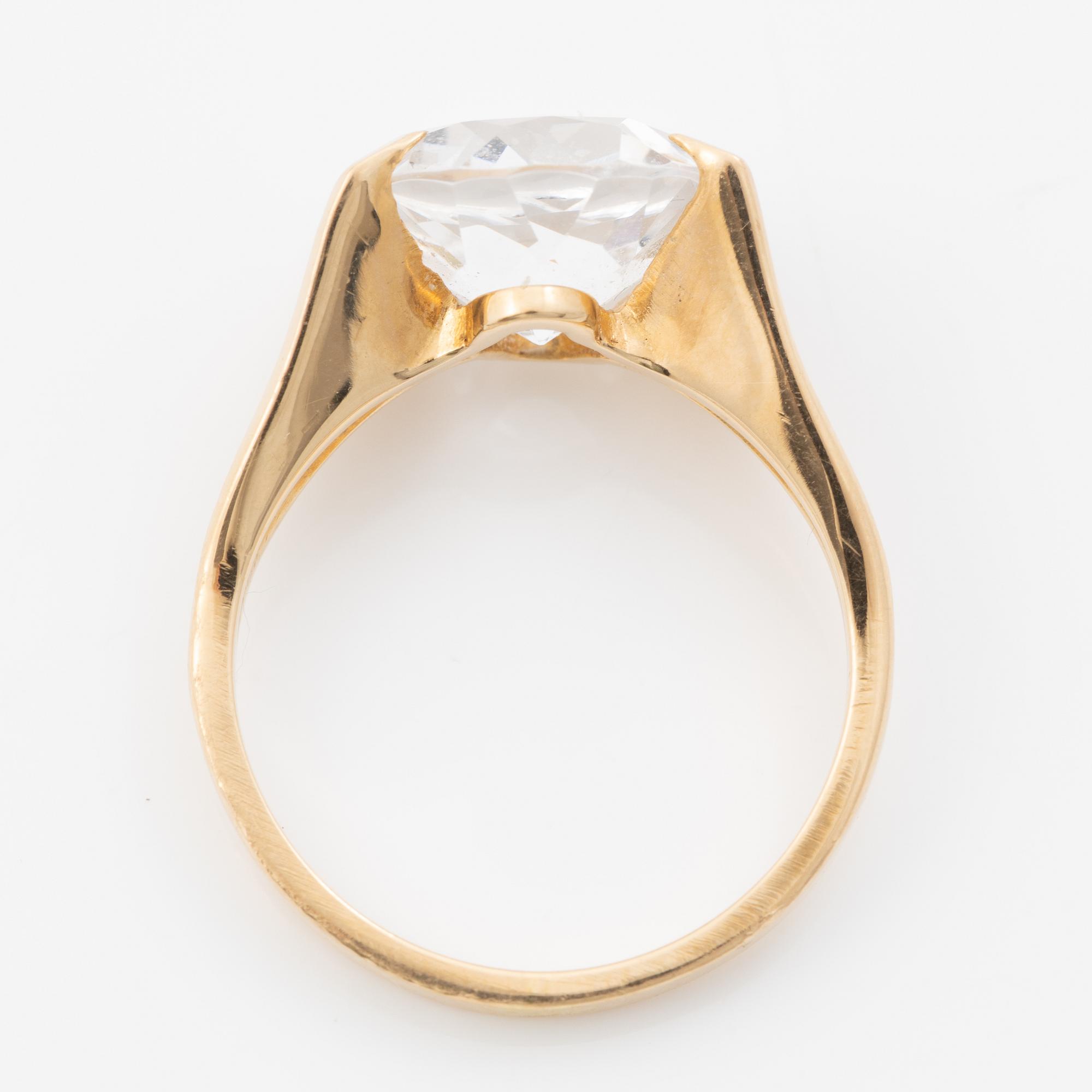 Ring, 18K gold with a synthetic white stone.