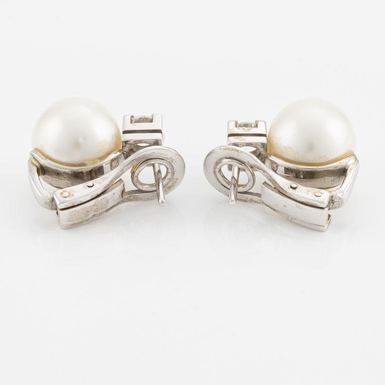 A pair of pearl and diamond earrings.