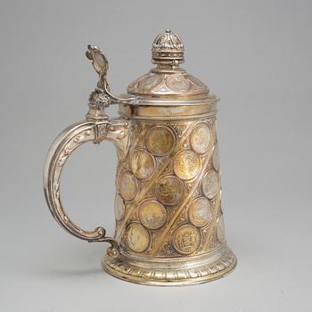 A late 19th century EPNS tankard with silver coins.