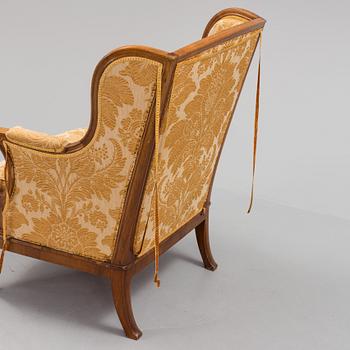 A Rococo style wing chair, first half of teh 20th Century.