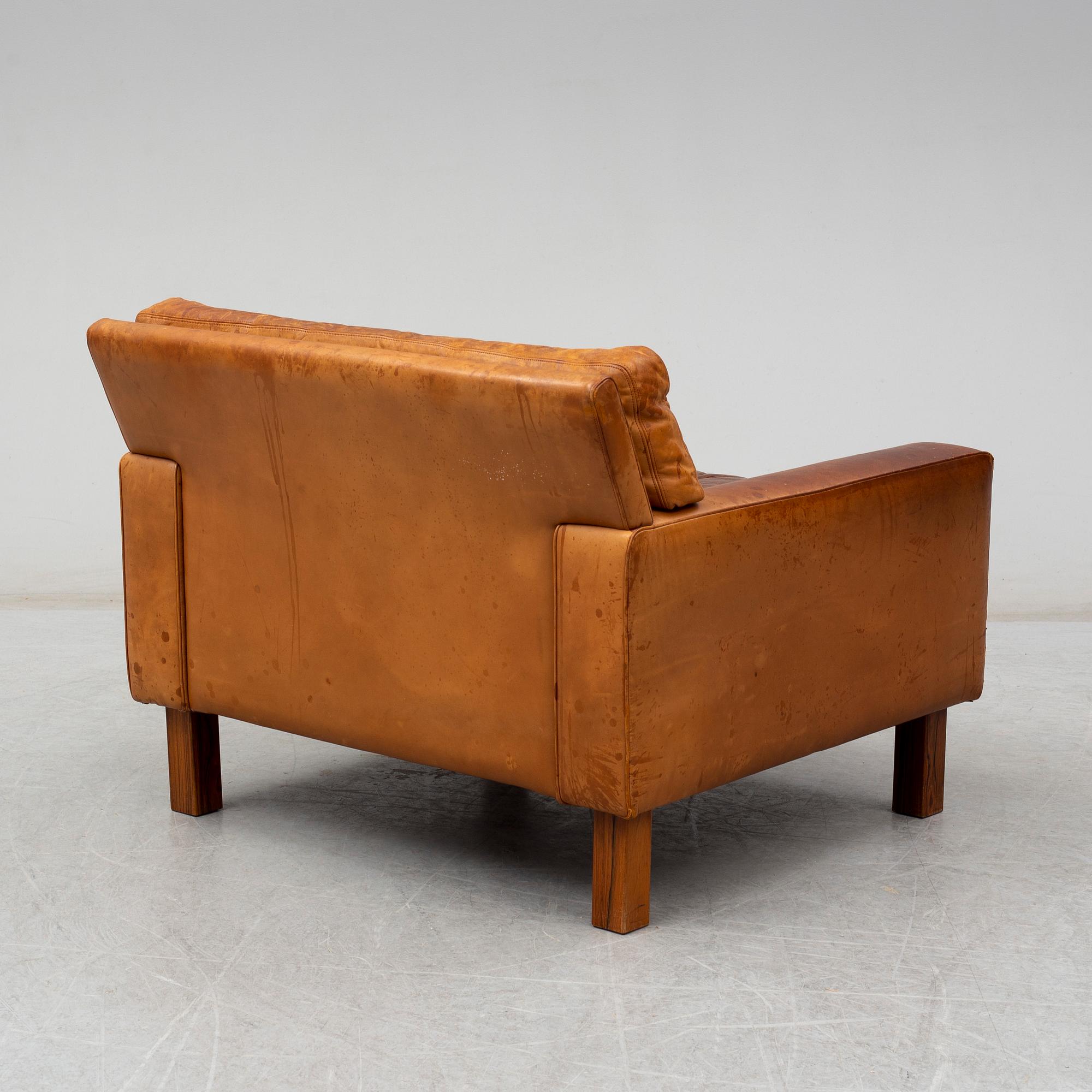A 1960's/1970's leather covered easy chair with rosewood legs.