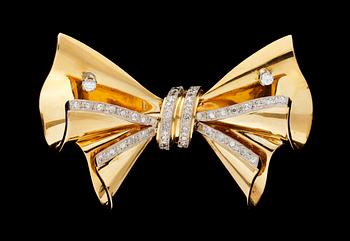 732. A 1946 gold and diamond ribbon brooch.