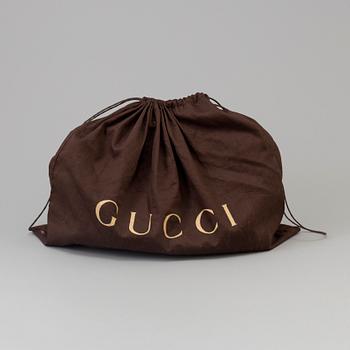 Handbag by Gucci.