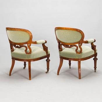 A pair of Russian armchairs and a table, late 19th century.