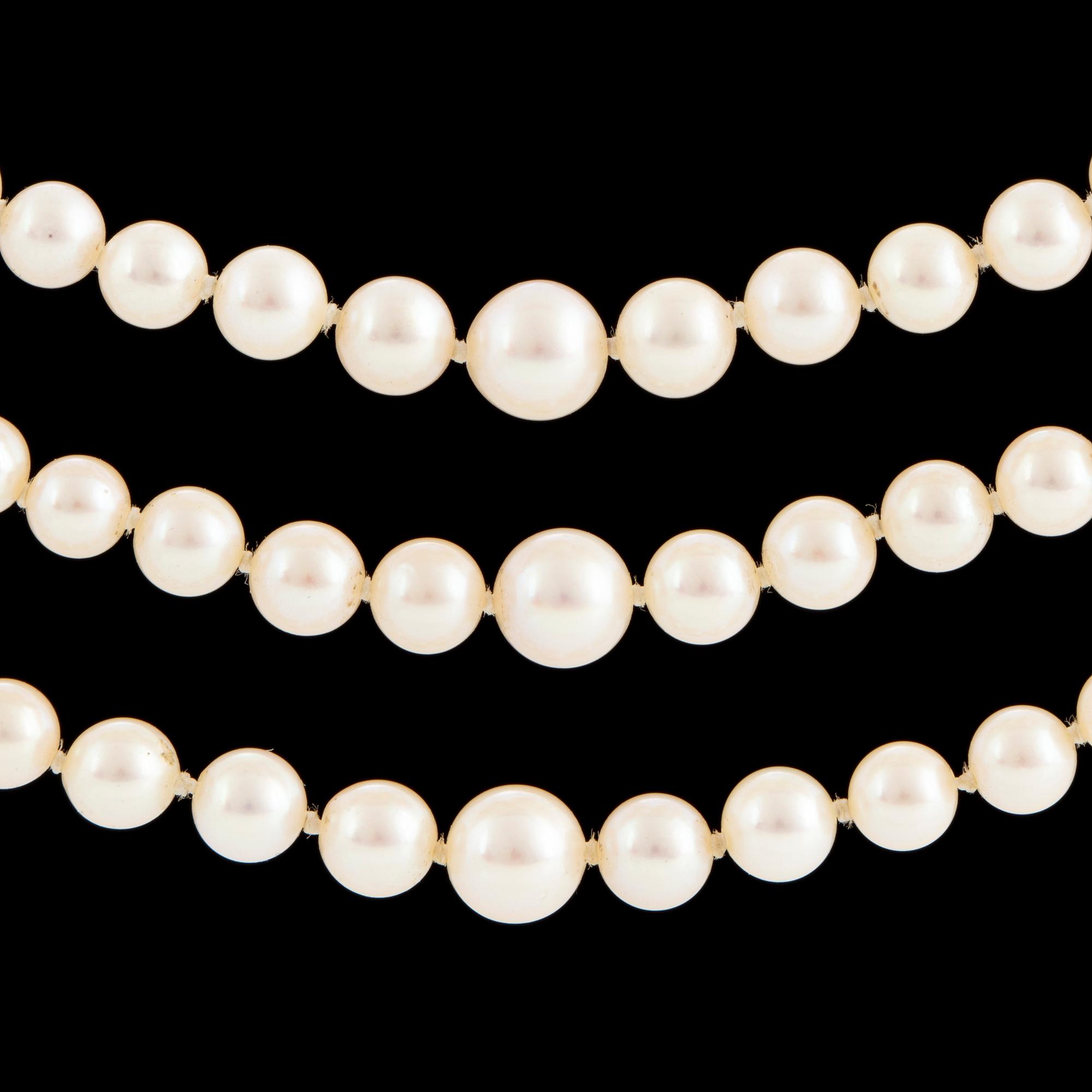 A three strand cultured pearl necklace.