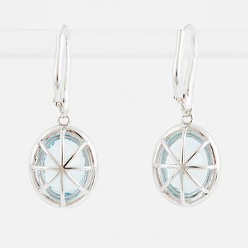A pair of 18K gold earrings set with faceted aquamarines.