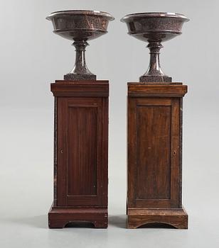 A pair of Swedish porpyry vases on wooden bases, Älvdalen, first half of the 19th century.