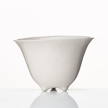 A rhinoserous shaped blanc de chine libation cup, Qing dynasty.