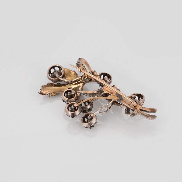 A BROOCH set with rose-cut diamonds.