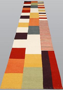An oriental flat weave carpet, c 488 x 83 cm.