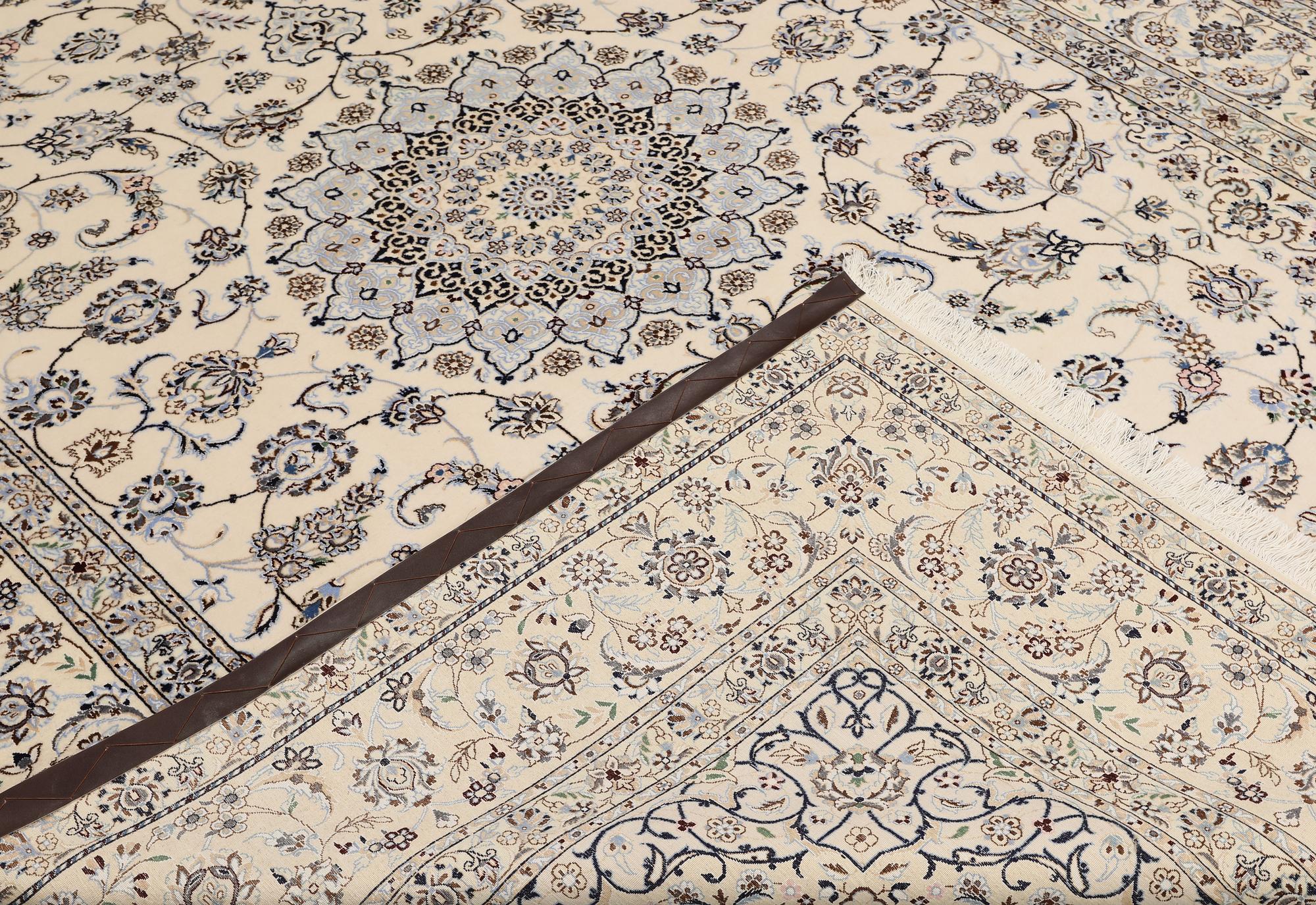A Nain, part silk carpet, 305 x 207 cm.